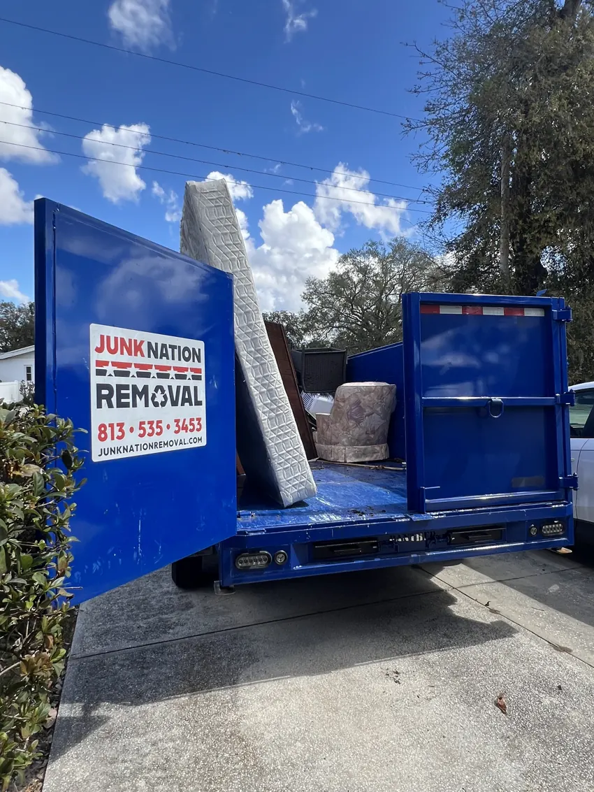 Junk Nation Removal trailer loaded with hauled-away junk on a Tampa Bay job