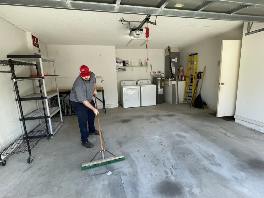 Junk Nation Removal crew member clearing out a garage during a cleanout